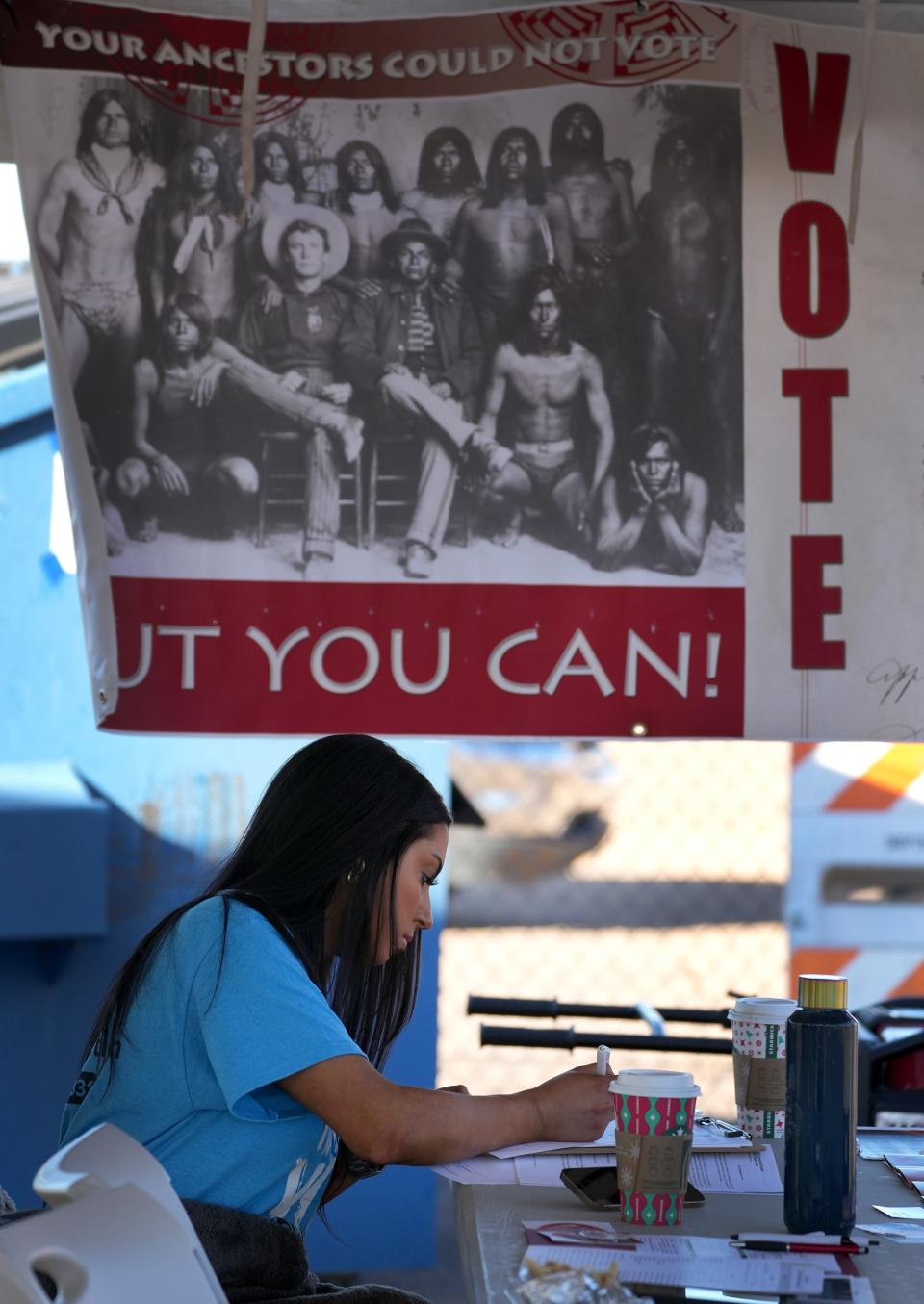 Catherine Folsom, volunteer with Native Vote and an ASU law student, helps with any issues voters might have with their ballot at the Salt River Tribal Recreation Center in Scottsdale, Arizona, Tuesday morning.