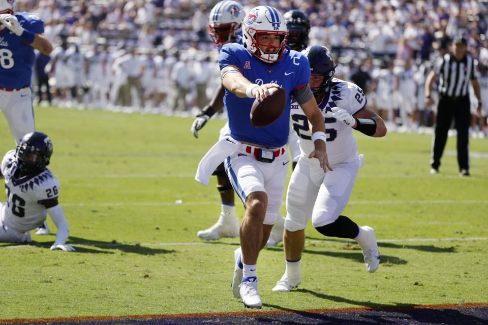 SMU quarterback Tanner Mordecai (8) scores a touchdown in front of TCU linebacker Wyatt Harris (25) during the first half of an NCAA football game in Fort Worth, Texas, Saturday, Sept. 25, 2021. (AP Photo/Michael Ainsworth)