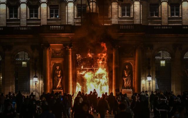 The entrance door of the city hall of Bordeaux burned during a demonstration - UGO AMEZ/SIPA/Shutterstock