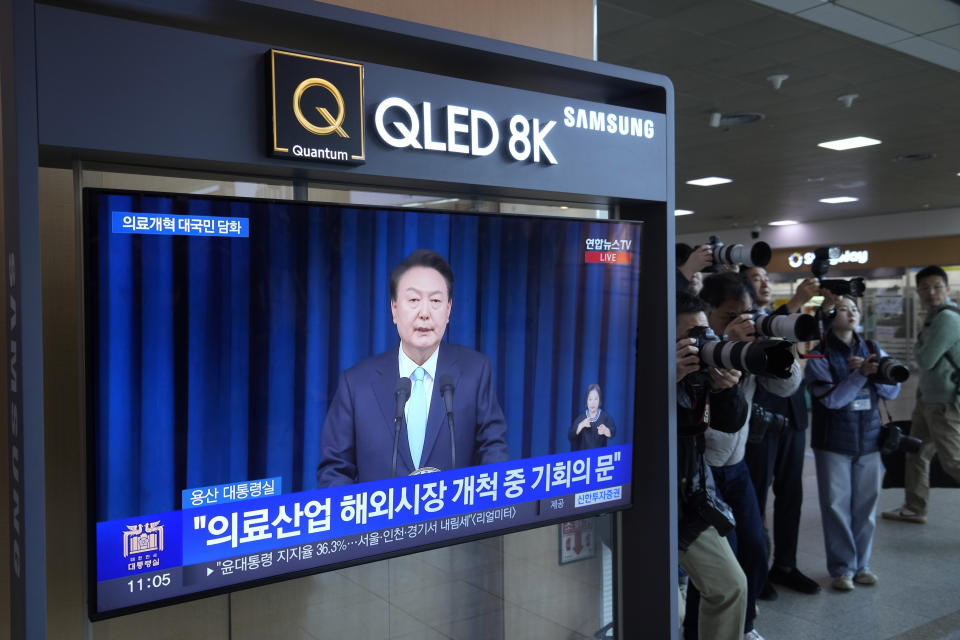 A TV screen shows the live broadcast of South Korean President Yoon Suk Yeol’s addressing the nation at the Seoul Railway Station in Seoul, South Korea, Monday, April 1, 2024. President Yoon vowed Monday not to back down in the face of vehement protests by doctors seeking to spike his plan to drastically increase medical school admissions, as he called their walkouts “an illegal collective action” that poses "a grave threat to our society.” (AP Photo/Ahn Young-joon)