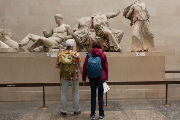 Visitors admire the sculpture of the ancient Greek Parthenon's Elgin Marbles Metopes in the British Museum. (Photo: Richard Baker via Getty Images)