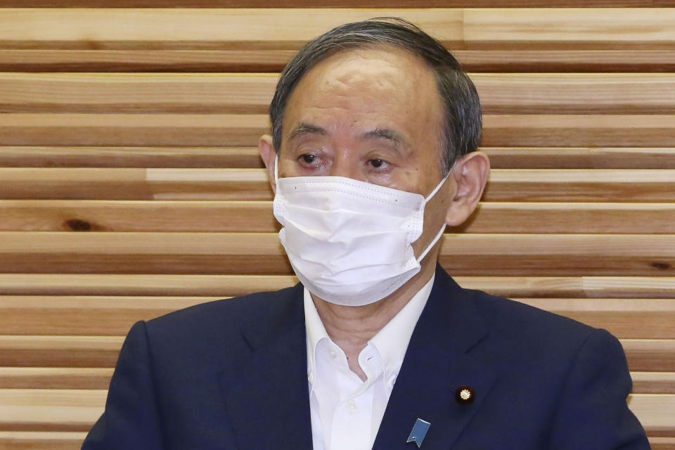 Japan's Prime Minister Yoshihide Suga attends a cabinet meeting at his official residence in Tokyo Friday, Sept. 3, 2021. Broadcaster NHK says Suga won't run for party leader, hinting he will resign as Japanese leader at the end of September. (Kyodo News via AP)