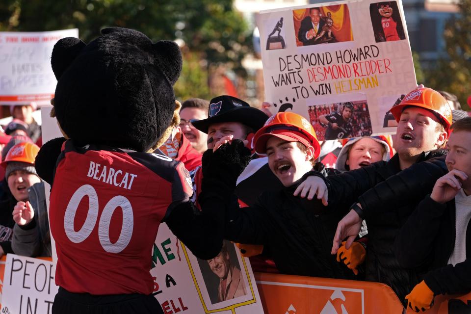 The University of Cincinnati Bearcat high fives fans during ESPN's 'College GameDay' Saturday, Nov. 6, 2021, at The Commons on UC Main Campus in Cincinnati.