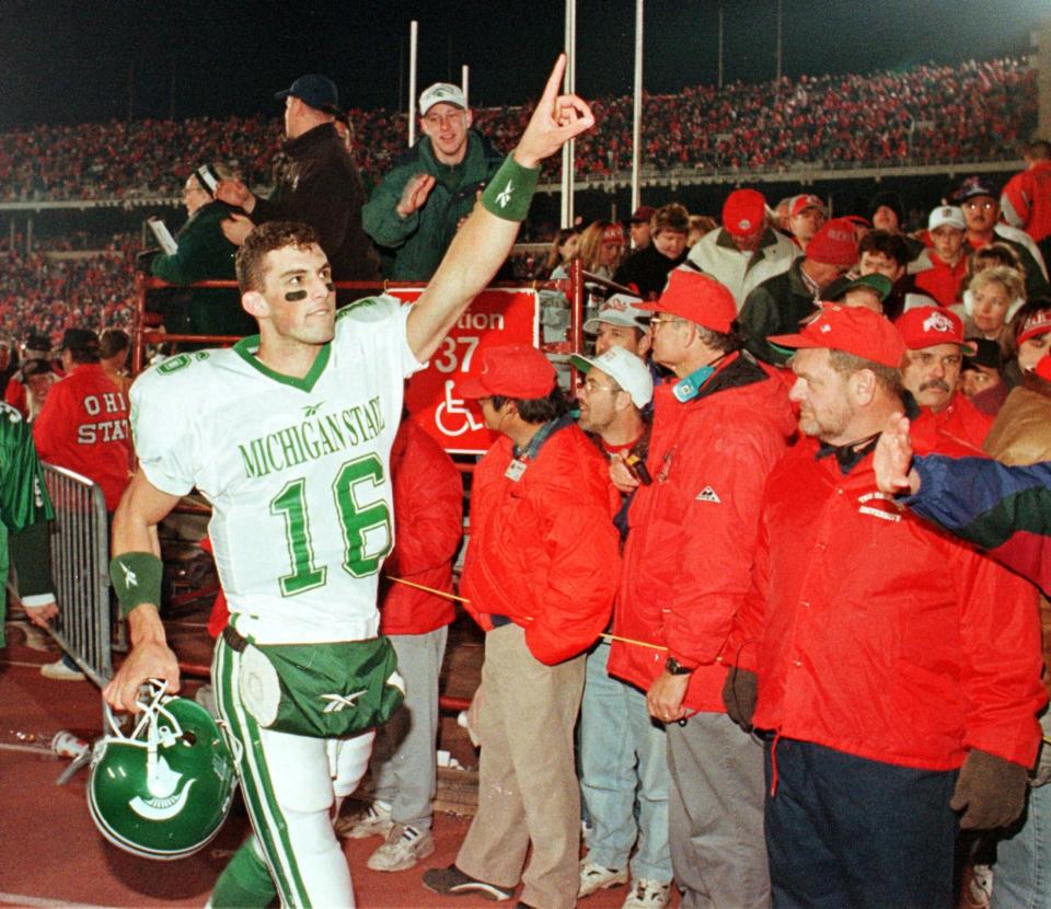 Michigan State quarterback Bill Burke (16) celebrates as he leaves the field after the Spartans defeated number one Ohio State Saturday, Nov. 7, 1998, in Columbus, Ohio.