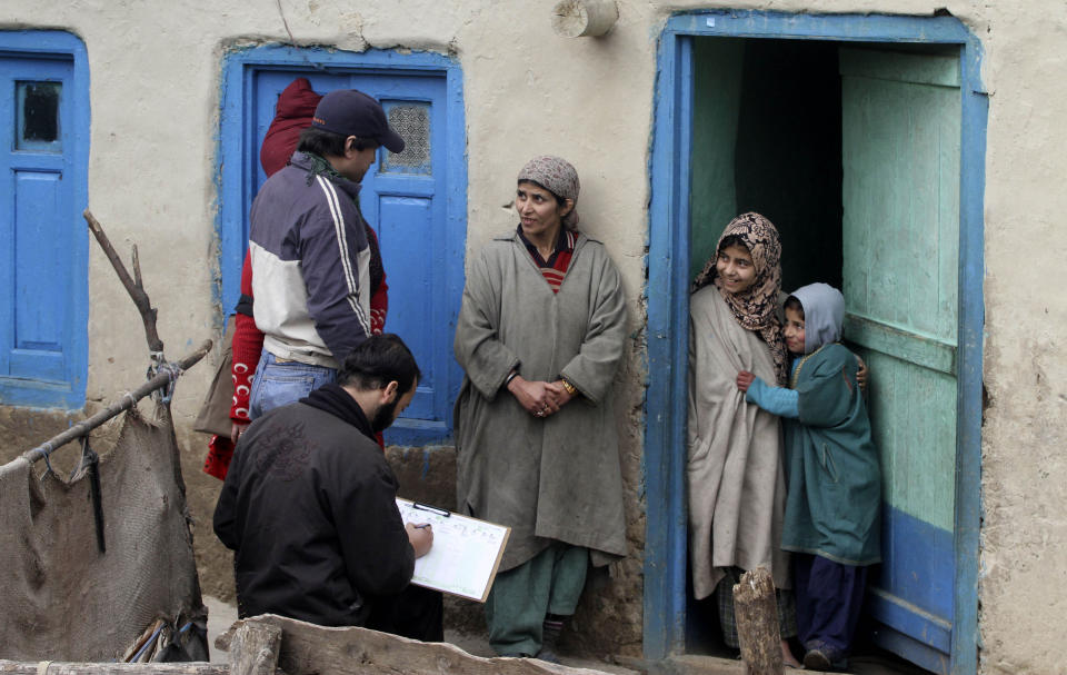 In this Wednesday, Feb. 9, 2011, file photo, census workers take details of a Kashmiri family on the outskirts of Srinagar, India. India has been embroiled in protests since December, when Parliament passed a bill amending the country's citizenship law. (AP Photo/Mukhtar Khan, File)