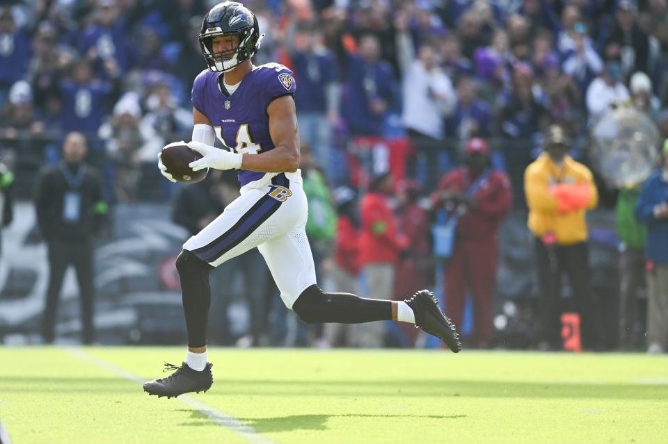 Nov 12, 2023; Baltimore, Maryland, USA; Baltimore Ravens safety Kyle Hamilton (14) returns a interception for a first quarter touchdown against the Cleveland Browns at M&T Bank Stadium. Mandatory Credit: Tommy Gilligan-USA TODAY Sports