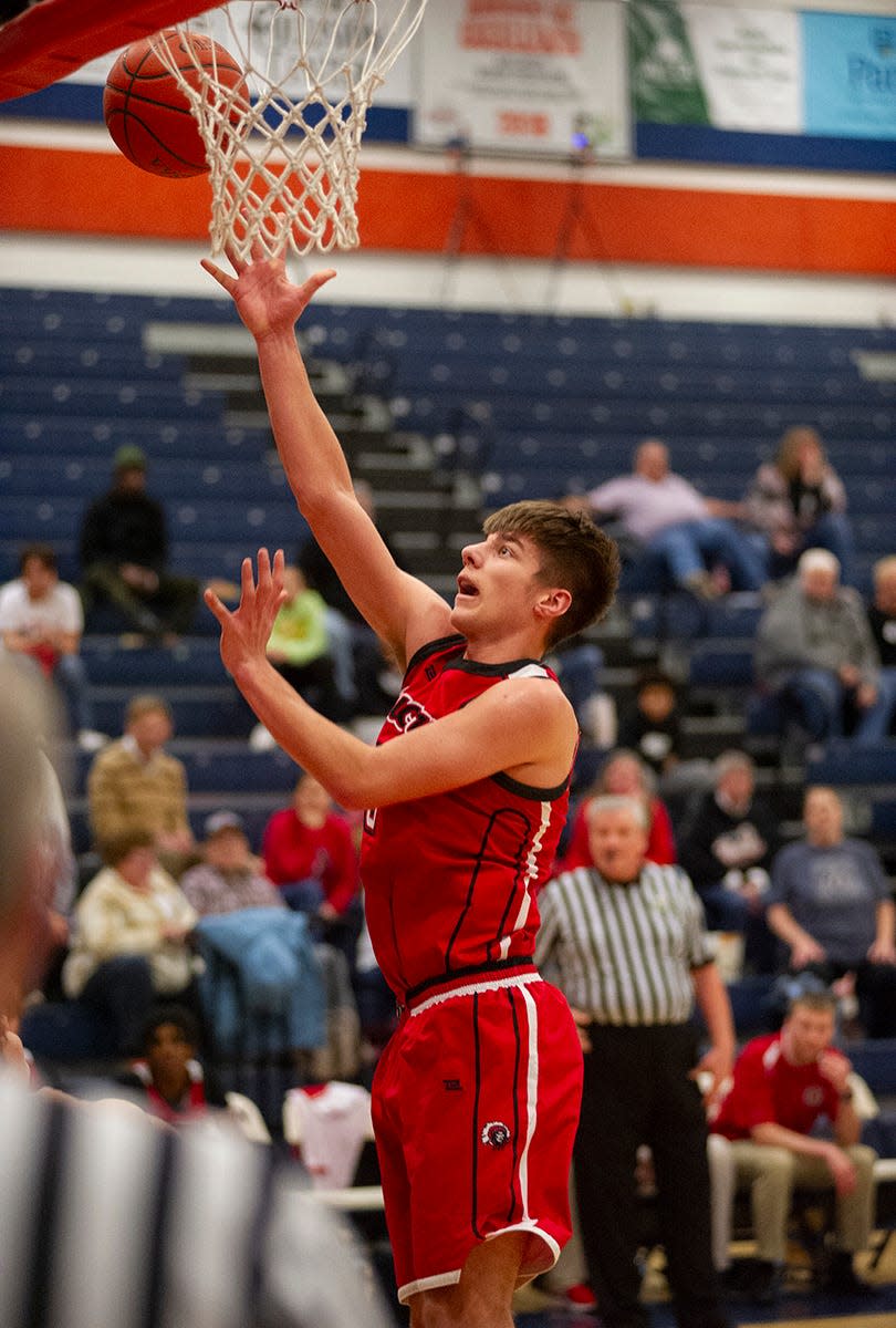 Bucyrus' Noah Burke finishes at the basket.