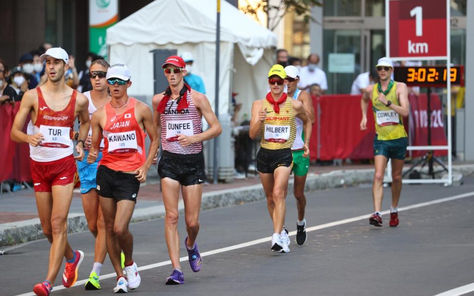 Marc Tur of Spain, Masatora Kawano of Japan, Evan Dunfee of Canada, Jonathan Hilbert of Germany and Rhydian Cowley of Australia in action in the men's 50km race walk. - REUTERS/Kim Hong-Ji