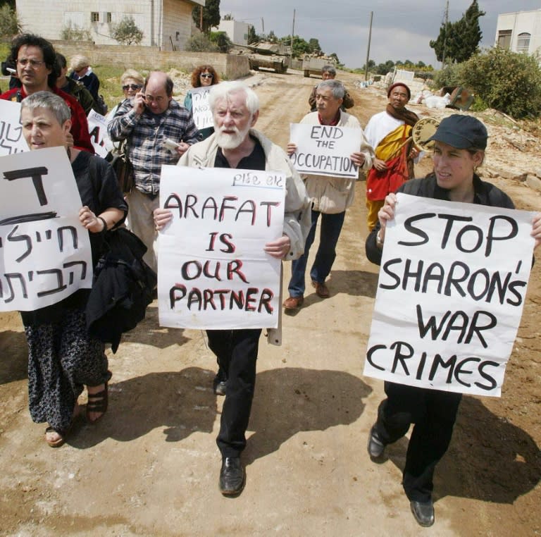 In this file photo taken on April 22, 2002, Gush Shalom peace activists, including group founder Uri Avneri (C), march towards the headquarters of Palestinian Authority president Yasser Arafat in the Israeli-occupied West Bank city of Ramallah