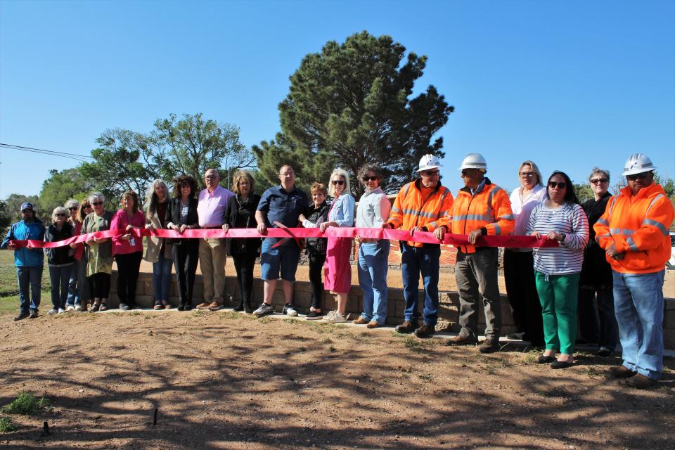 Levelland Mayor Barbra Pinner cuts the ribbon on the city's new mosaic highway monument on Monday in Levelland.