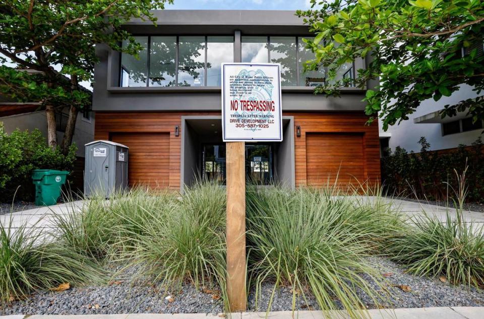 A no-trespassing sign stands in front of newly built townhouses along Coconut Grove Avenue in Coconut Grove on Thursday, Feb. 9, 2023. Many of the townhouse buyers have been waiting years to move into their newly constructed homes built by Doug Cox/Drive Development. Cox kept extending the closing dates of the properties. The buyers, some of whom have contracts going back to 2018, still have not been able to move in.