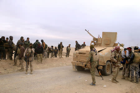 Members of the Lions of the Tigris, a group of Sunni Arab fighters and part of the Hashid Shaabi (Popular Mobilization Comimittee) take part during a military operation against Islamic State militants in Shayyalah al-Imam, Iraq November 30, 2016. REUTERS/Thaier Al-Sudani