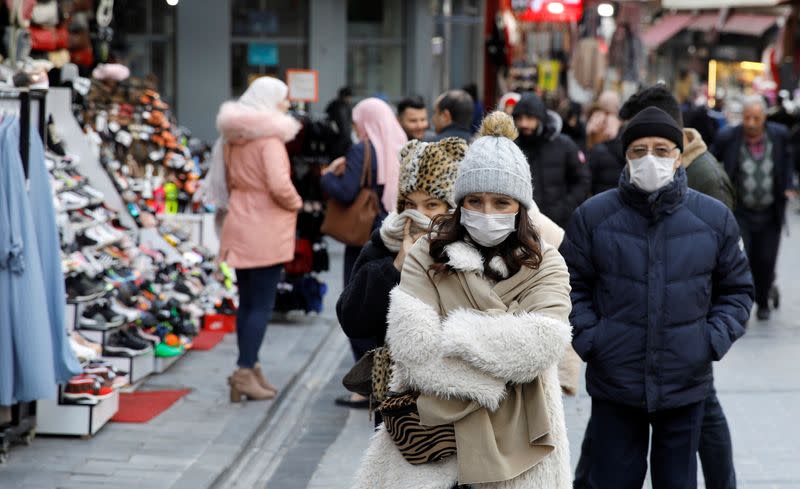 People wear protective face masks due to coronavirus concerns in Istanbul