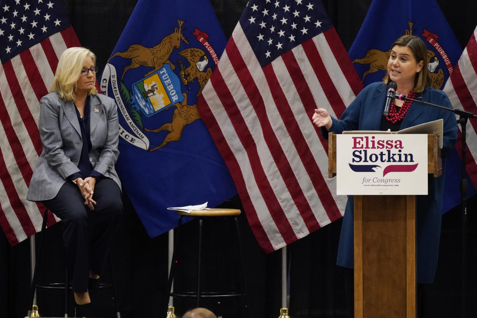 U.S. Rep. Elissa Slotkin, D-Mich., speaks as Rep. Liz Cheney, R-Wyo., listens during a campaign rally, Tuesday, Nov. 1, 2022, in East Lansing, Mich. Slotkin emphasized how a shared concern for a functioning democracy can unite Democrats and Republicans despite policy disagreements. (AP Photo/Carlos Osorio)