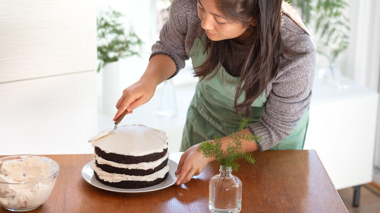 Person frosting cake