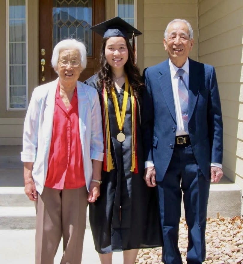 Michelle at her college graduation with her grandparents