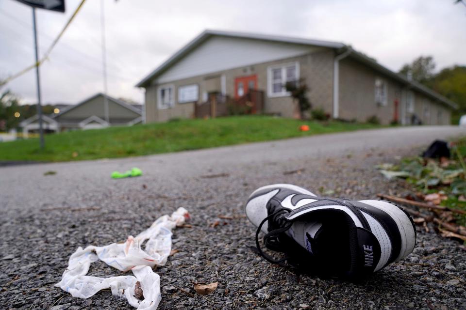 Debris, mixed with personal items including shoes, are scattered after a fatal shooting near the Chevy Chase Community Center in White Township, Indiana County, Pa., on Sunday. State police in Indiana County said troopers, local officers and emergency services responded at 12:35 a.m. Sunday to the shooting at the center in White Township, about 50 miles northeast of Pittsburgh.
