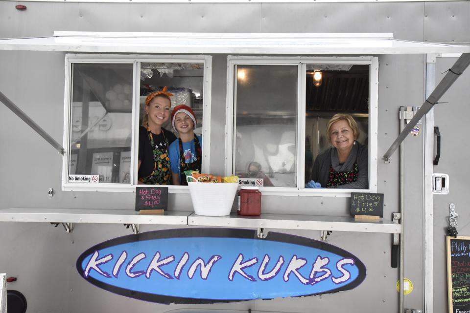 Lisa Uptgraft, owner of Kickin Kurbz mobile kitchen, poses for a photo along with her son, Jaxon Uptgraft, and her mother, Rita Russ, on Friday, Jan. 14, 2022 in Battle Creek, Mich.