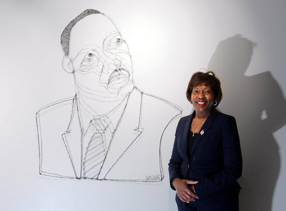 Demetries Neely poses next to a wire portrait of Dr. Martin Luther King Jr. at the King Arts Complex in 2017. Neely will be leaving her position as executive director and CEO of the organization at the end of June.