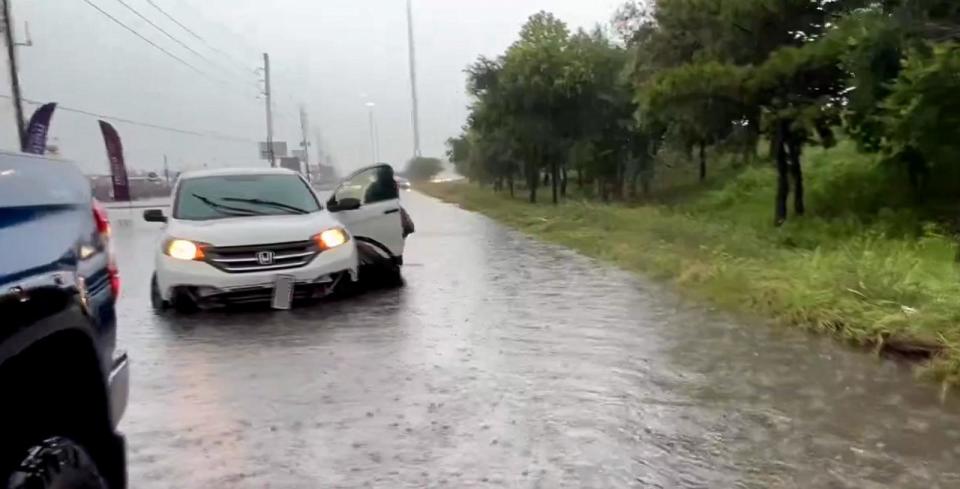 PHOTO: In this screen grab from a video posted on social media, a stranded motorist exits their vehicle on a flooded road in the Houston, Texas, area, on May 2, 2024. (@StormChaserHTX)