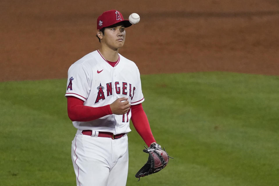 Los Angeles Angels starting pitcher Shohei Ohtani (17) tosses a ball in the air on the mound during a baseball game against the Chicago White Sox Sunday, April 4, 2021, in Anaheim, Calif. (AP Photo/Ashley Landis)