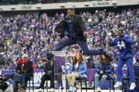 Former New York Giants player Michael Strahan jumps in the air during a halftime ceremony at an NFL football game between the New York Giants and the Philadelphia Eagles, Sunday, Nov. 28, 2021, in East Rutherford, N.J. (AP Photo/Corey Sipkin)