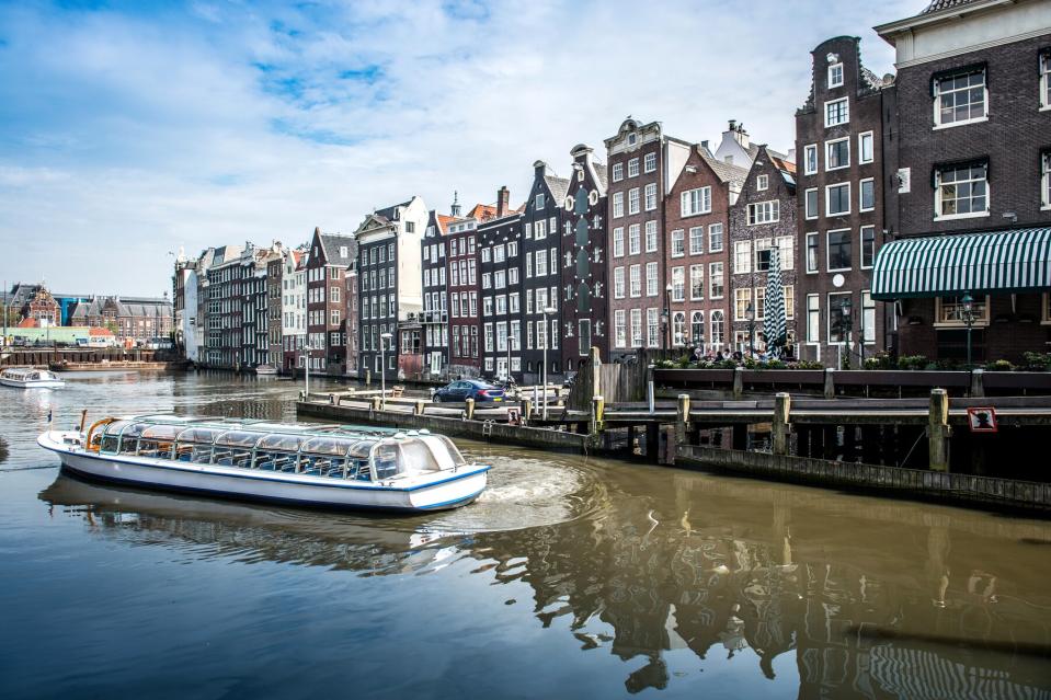 The Yachts And Pier Of Amstel River In Amsterdam, The Netherlands