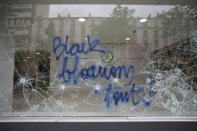 A message is written on the window of an auto dealership which was attacked by youths who took part in a demonstration in protest of the government's proposed labour law reforms in Paris, France, May 26, 2016. REUTERS/Charles Platiau