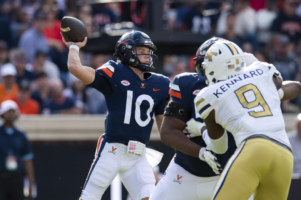 Virginia quarterback Anthony Colandrea (10) throws a pass as Georgia Tech defensive lineman Kyle Kennard (9) rushes in during the first half of an NCAA college football game Saturday, Nov. 4, 2023, in Charlottesville, Va. (AP Photo/Mike Caudill)