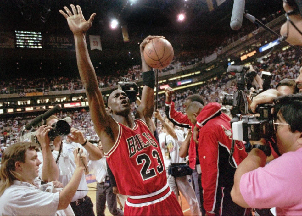 The Chicago Bulls Michael Jordan celebrates after the Bulls beat the Phoenix Suns 99-98 to win their third consecutive NBA title in Phoenix, June 20, 1993. Jordan scored 33 points and now holds the record for the highest scoring average in finals history, 41.0, eclipsing Rick Barry's 1967 standard of 40.8. (AP Photo/John Swart)