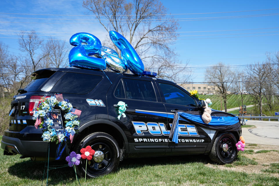 Memorials have shown up around the crash site and police station for Office Tim Unwin after he died in a double-fatal car crash Friday morning.