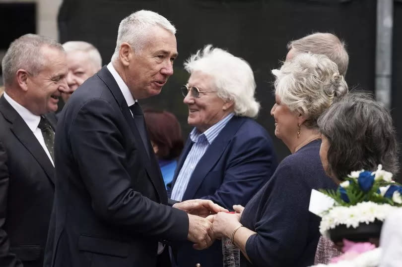 Jon Boutcher at the wreath-laying ceremony at the Memorial to the victims of the Dublin and Monaghan bombings seen here shaking hands with people