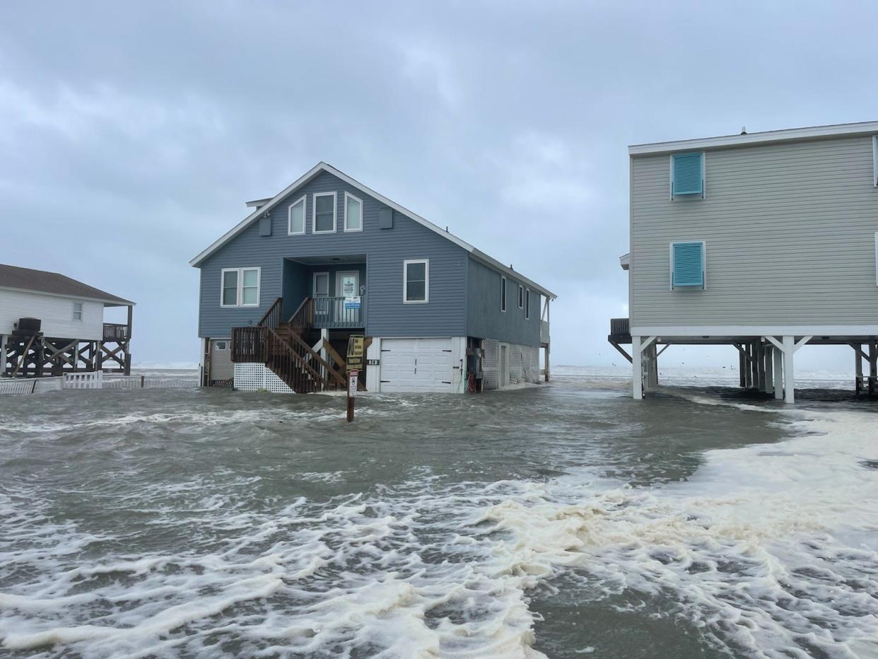 Homes and cars are partially submerged as the combination of a high tide and storm surge from Hurricane Ian left part of Ocean Isle Beach in Brunswick County flooded on Sept. 30, 2022.