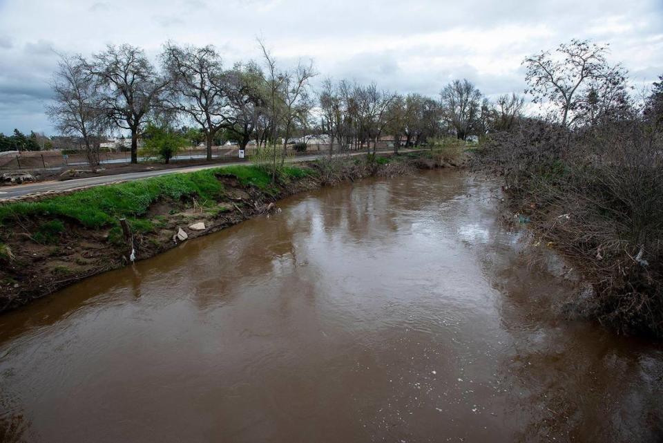 Bear Creek flows past a foot bridge near West 25th Street in Merced, Calif., on Tuesday, March 14, 2023.