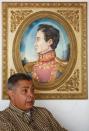 Angel Vivas, a retired army general and anti-Maduro protester, speaks in front of a painting of South American revolutionary hero Simon Bolivar during an interview with Reuters in Caracas March 31, 2015. REUTERS/Carlos Garcia Rawlins