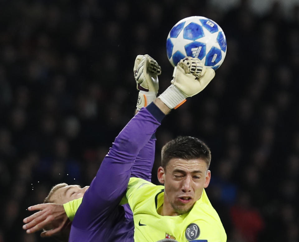 PSV goalkeeper Jeroen Zoet clears the ball before Barcelona defender Clement Lenglet can head the ball during a Group B Champions League soccer match between PSV Eindhoven and Barcelona at the Philips stadium in Eindhoven, Netherlands, Wednesday, Nov. 28, 2018. (AP Photo/Peter Dejong)