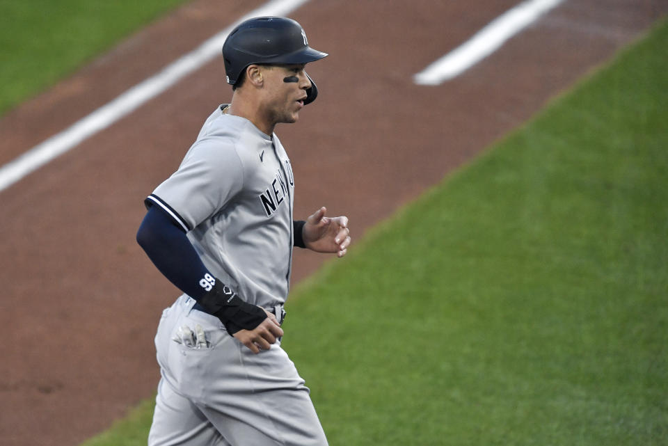 New York Yankees' Aaron Judge reacts heads to the dugout after scoring against the Toronto Blue Jays on a triple by Aaron Hicks during the first inning of a baseball game in Buffalo, N.Y., Tuesday, Sept. 22, 2020. (AP Photo/Adrian Kraus)