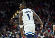 Minnesota Timberwolves forward Anthony Edwards smiles after scoring against the Portland Trail Blazers during the second half of an NBA basketball game in Portland, Ore., Tuesday, Jan. 25, 2022. (AP Photo/Craig Mitchelldyer)