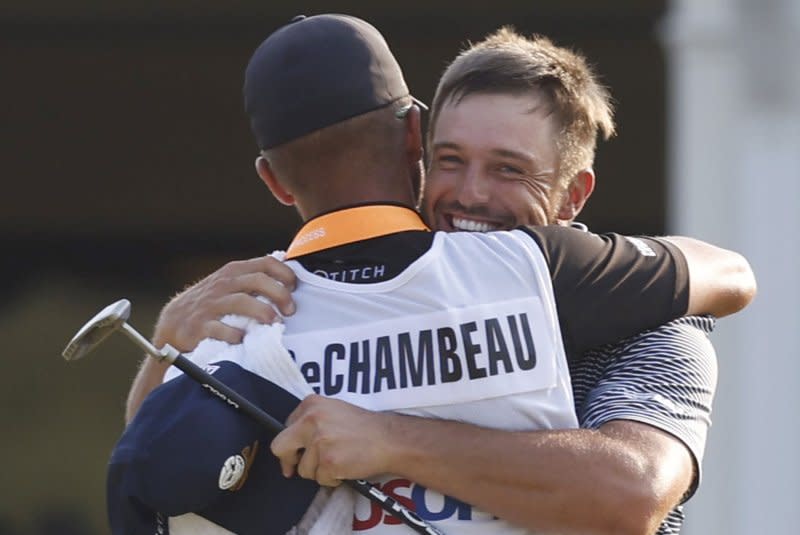 Bryson DeChambeau (R) celebrates with caddie Gregory Bodine after winning the 124th U.S. Open on Sunday at Pinehurst Resort & Country Club in Pinehurst, N.C. Photo by John Angelillo/UPI