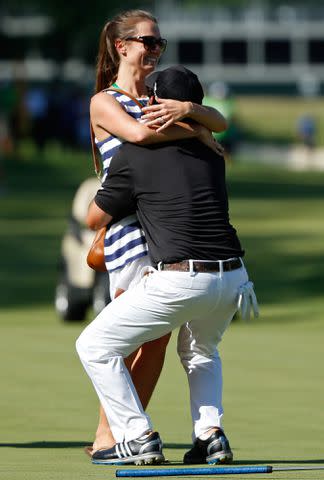 <p>Gregory Shamus/Getty</p> Brian Harman and Kelly Van Slyke at the John Deere Classic in 2014