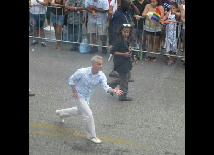 From Karen Belgrad: "At my friend's apartment, overlooking the parade route, he casually tosses out beads...and Chicago Mayor Rahm Emanuel catches them with ease!  OK, and a little lunging!)" 