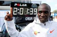 FILE PHOTO: Kenya's Eliud Kipchoge celebrates winning the Berlin Marathon alongside a clock showing his World Record breaking time in Berlin, Germany - Sep 16, 2018. REUTERS/Fabrizio Bensch/File Photo