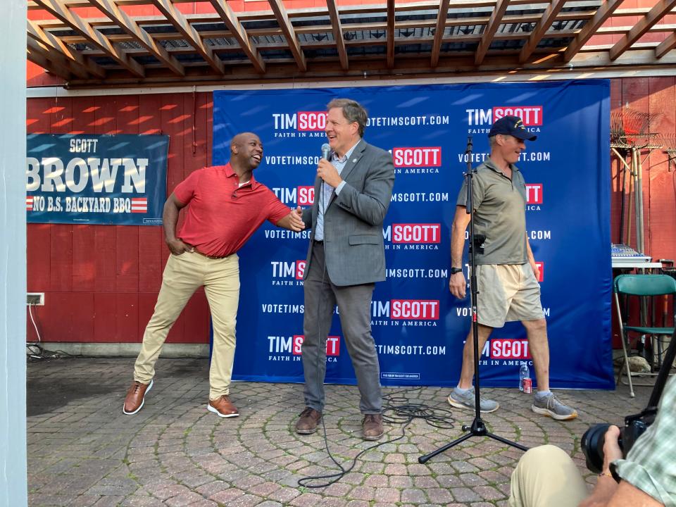 South Carolina Republican U.S. Senator Scott Brown, a 2024 GOP presidential candidate, jostles with New Hampshire Gov. Chris Sununu ahead of Scott's campaign stop in Rye on Thursday, Sept. 7, 2023. To the right is former U.S. Senator Scott Brown, who along with his wife hosted Scott on Thursday as part of their presidential candidate forum series.