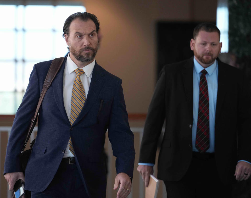 Defense Attorney Reid Elkus and defendant Randy Roedema walk into the Adams County Justice Center for the start of a trial of two of the police officers charged in the death of Elijah McClain, Wednesday, Sept. 20, 2023, in Brighton Colo. (AP Photo/Jack Dempsey)