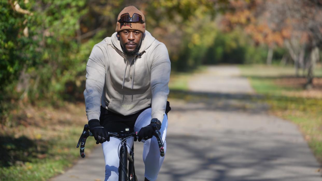 Former Ohio State offensive lineman Marcus Hall works out on his bicycle as he now hopes to become a Columbus firefighter.