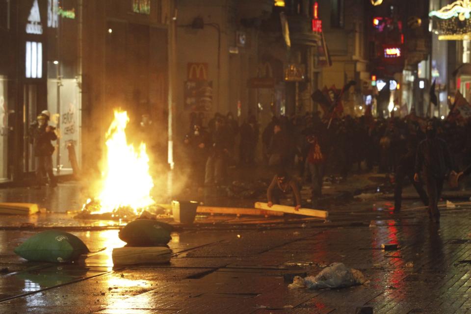 Demonstrators set barricades on fire as they clash with riot police during a protest against internet censorship in Istanbul