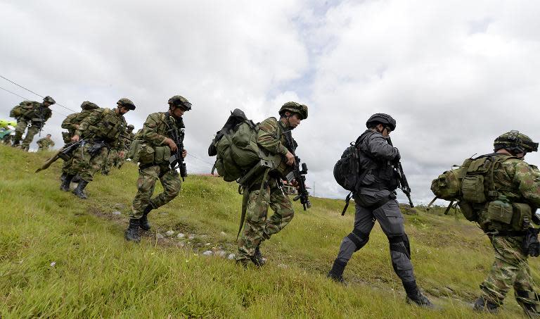 Colombian troops pictured about to board a helicopter in Quibdo, Choco province, in a Ministry of Defense photo released on November 19, 2014