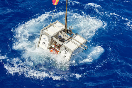 The Skaff lander floats next to the research vessel DSSV Pressure Drop above the Pacific Oceans’s Mariana Trench in an undated photo released by the Discovery Channel May 13, 2019. Atlantic Productions for Discovery Channel/Reeve Jolliffe/Handout via REUTERS.