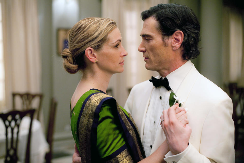 Julia Roberts and Billy Crudup are seen facing each other closely in an intimate dance, Roberts in a green formal outfit and Crudup in a white tuxedo in scene from "Eat Pray Love"