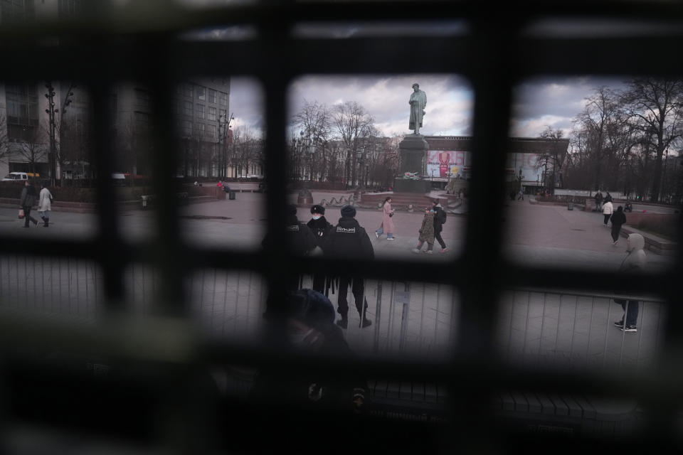 Seen from a police van police officers wearing face masks to help curb the spread of the coronavirus patrol a Pushkin square in Moscow, Russia, Thursday, Nov. 4, 2021. The Moscow authorities banned their traditional "Russian March" in Moscow celebrating People's Unity Day due to the COVID-19 pandemic. (AP Photo/Pavel Golovkin)